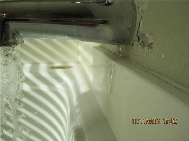 TUB DOWN SPOUT LEAKS & GOES BEHIND SHOWER WALL